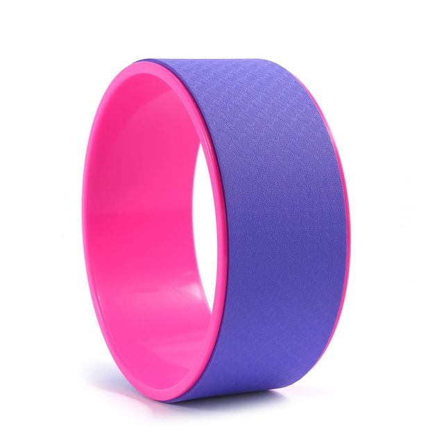 Purple and pink yoga wheel on a white background